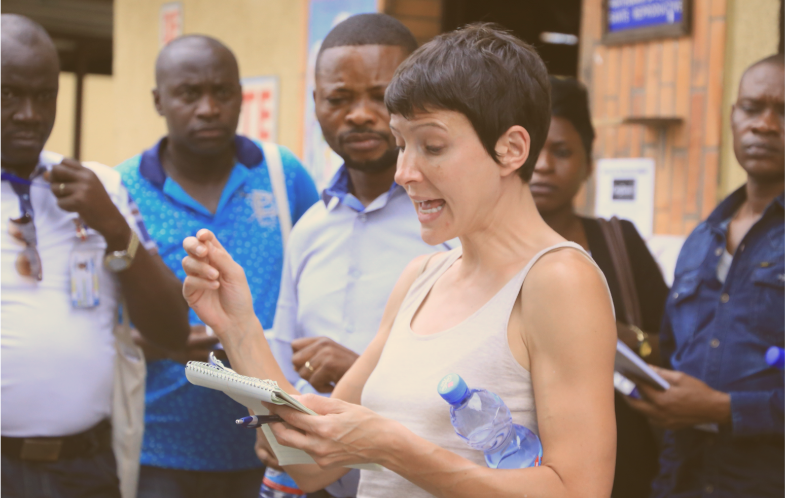 Alia reading from notes to a group of people